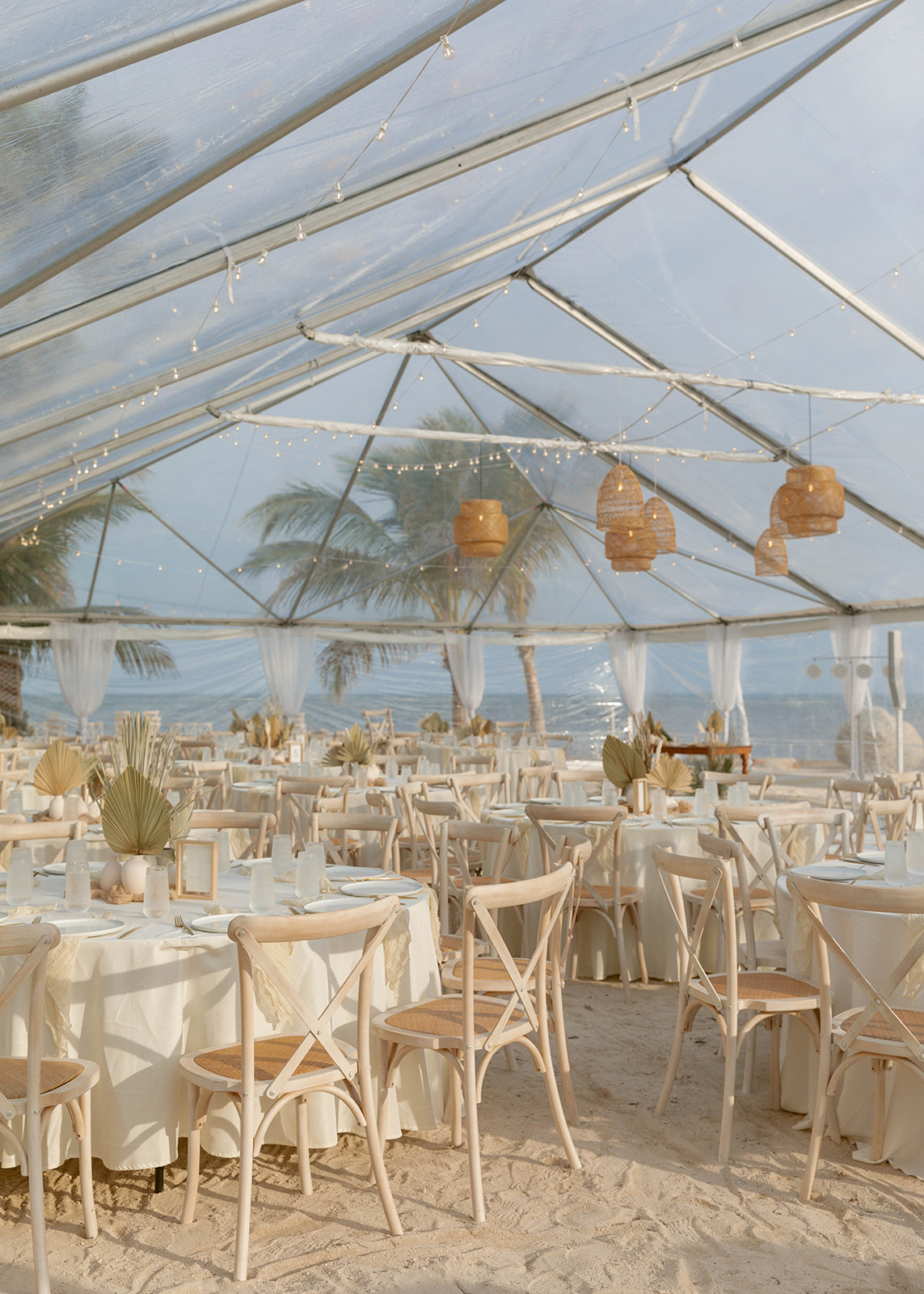 A beautiful coastal Florida wedding reception in a clear tent right by the ocean.