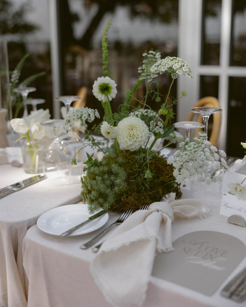 Wedding ceremony beneath a floral arch overlooking the St. Johns River at Epping Forest Country Club