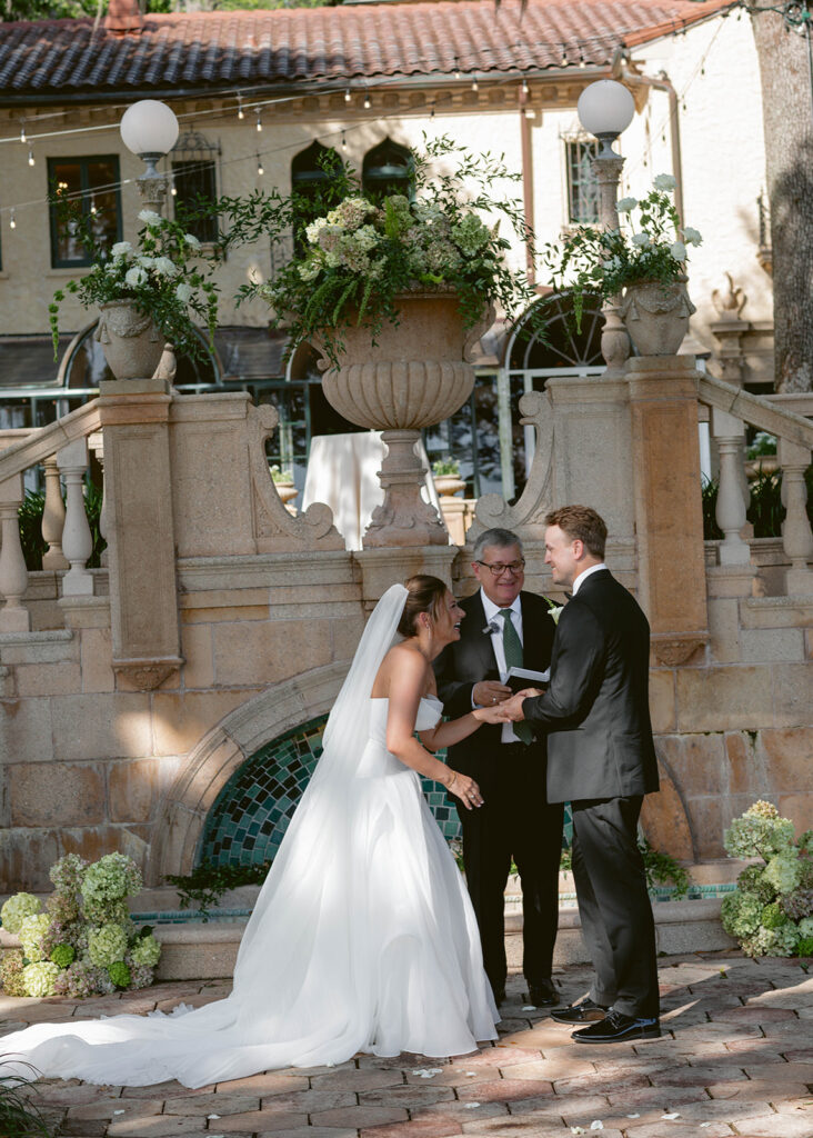 Black and white photo of the bride and groom kissing on the terrace at Epping Forest Country Club