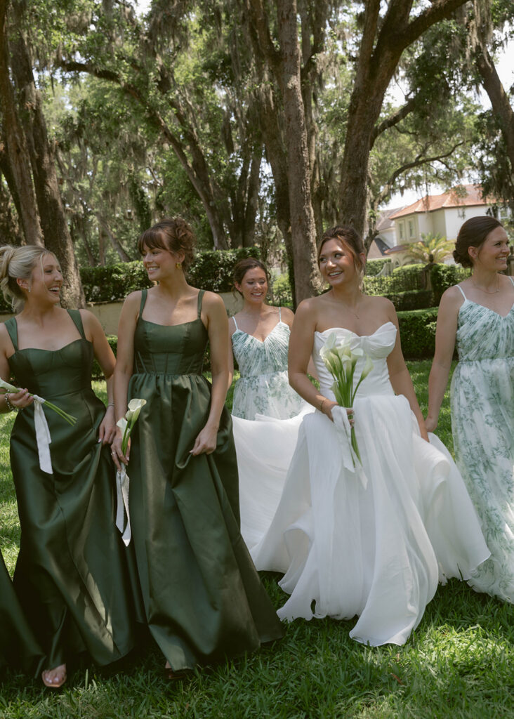 Bride with flower girls in sage green dresses on the lawn at Epping Forest Country Club, Jacksonville