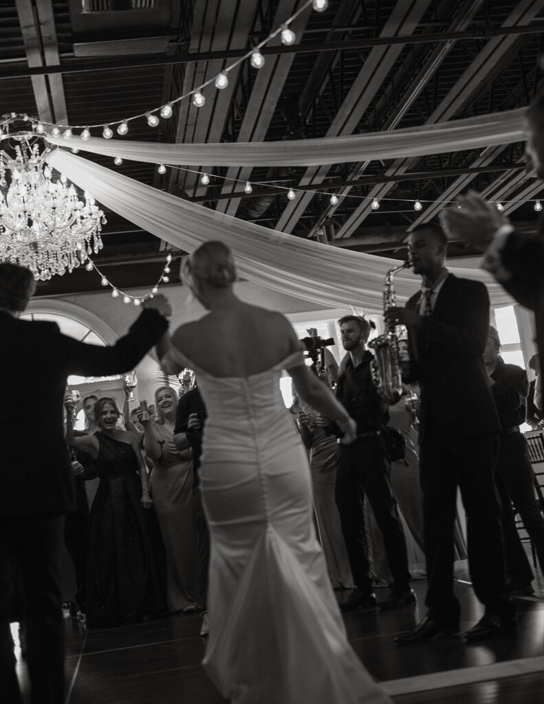 Bride dancing under string lights at her St. Augustine, Florida wedding reception