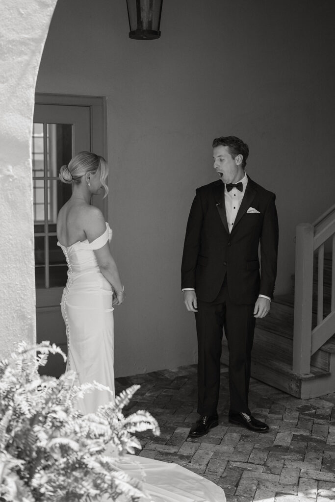Bride and groom sharing a quiet moment near a staircase before their St. Augustine wedding ceremony