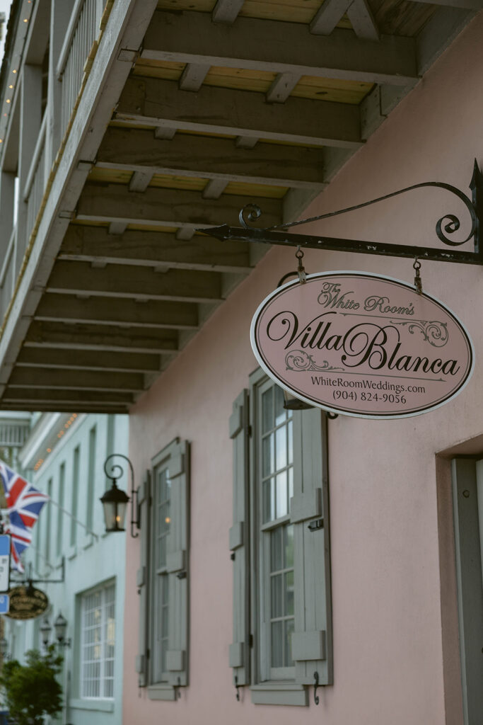 The Villa Blanca sign on a pastel building in St. Augustine, Florida, the wedding venue