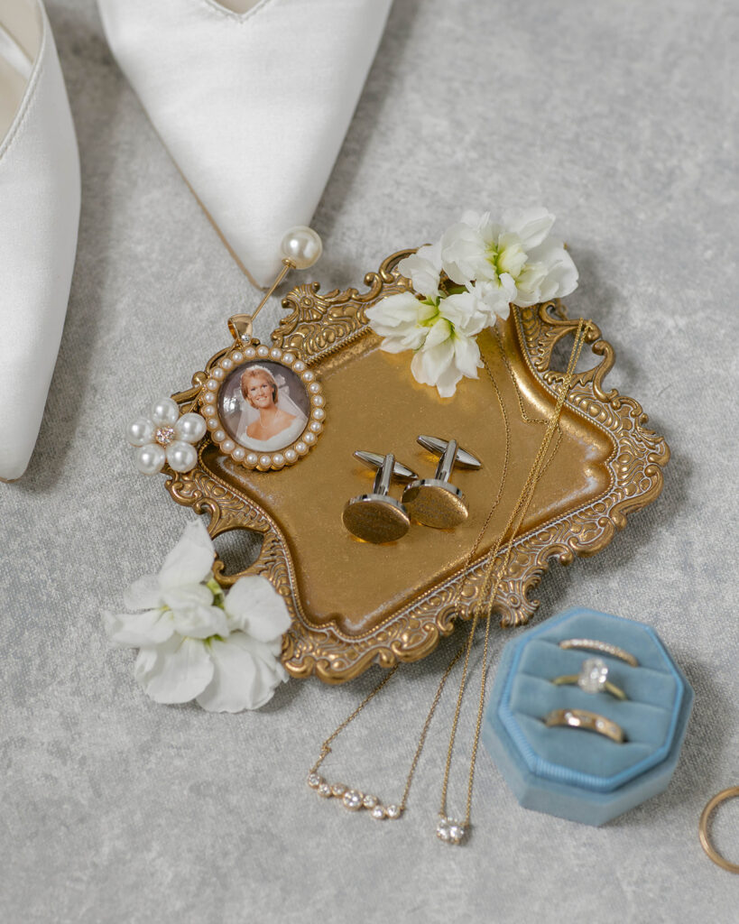 Vintage gold tray with cufflinks, rings, and a locket for the groom's getting-ready details, St. Augustine wedding