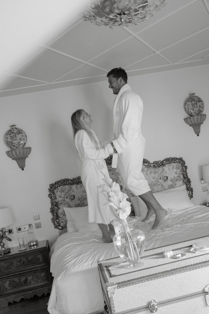Black and white candid of the couple in robes before their Lake Como elopement