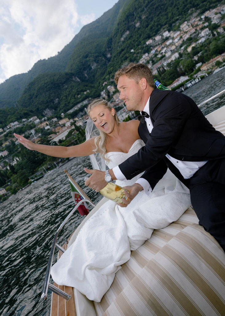 Bride and groom laughing together in a candid boat moment on Lake Como
