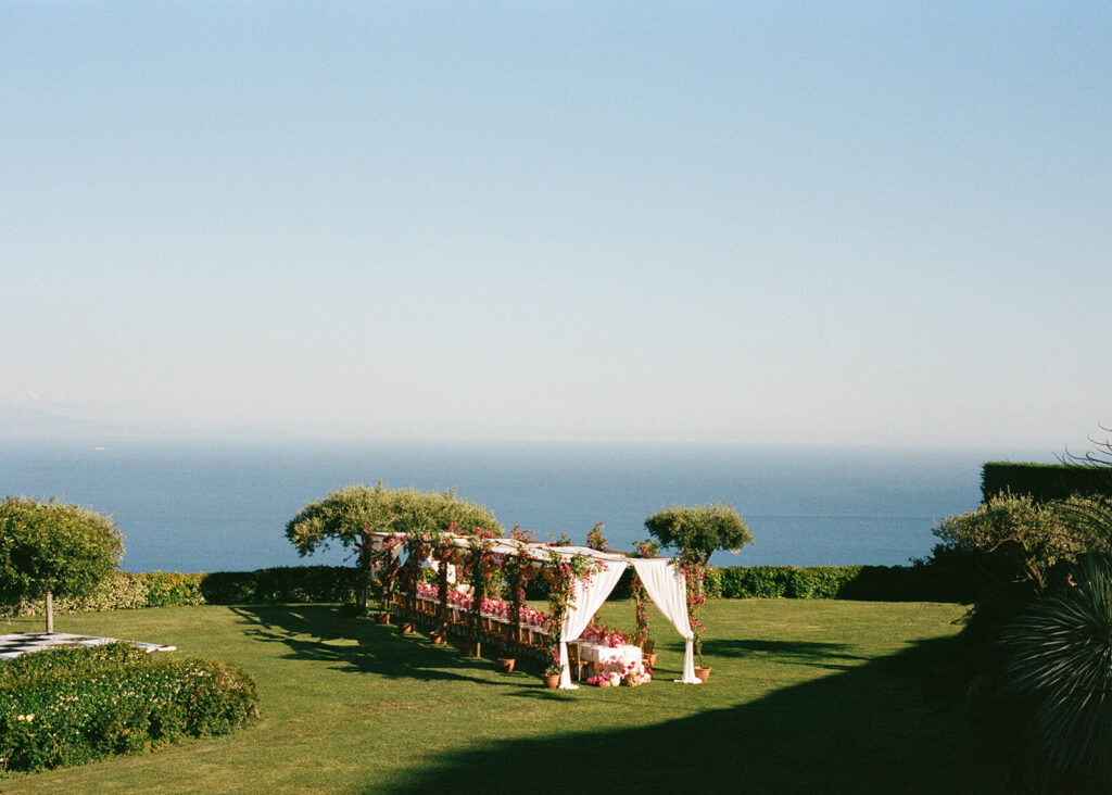 Ceremony aisle draped canopy overlooking the Amalfi Coast at Villa Cimbrone