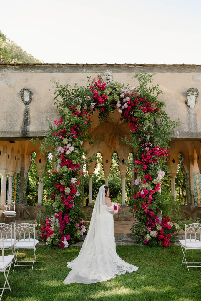 Rose and pink floral archway marking the ceremony entrance at Villa Cimbrone