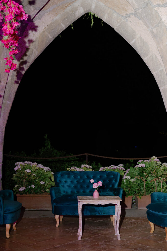 Candlelit stone archway entrance draped in vines at Villa Cimbrone