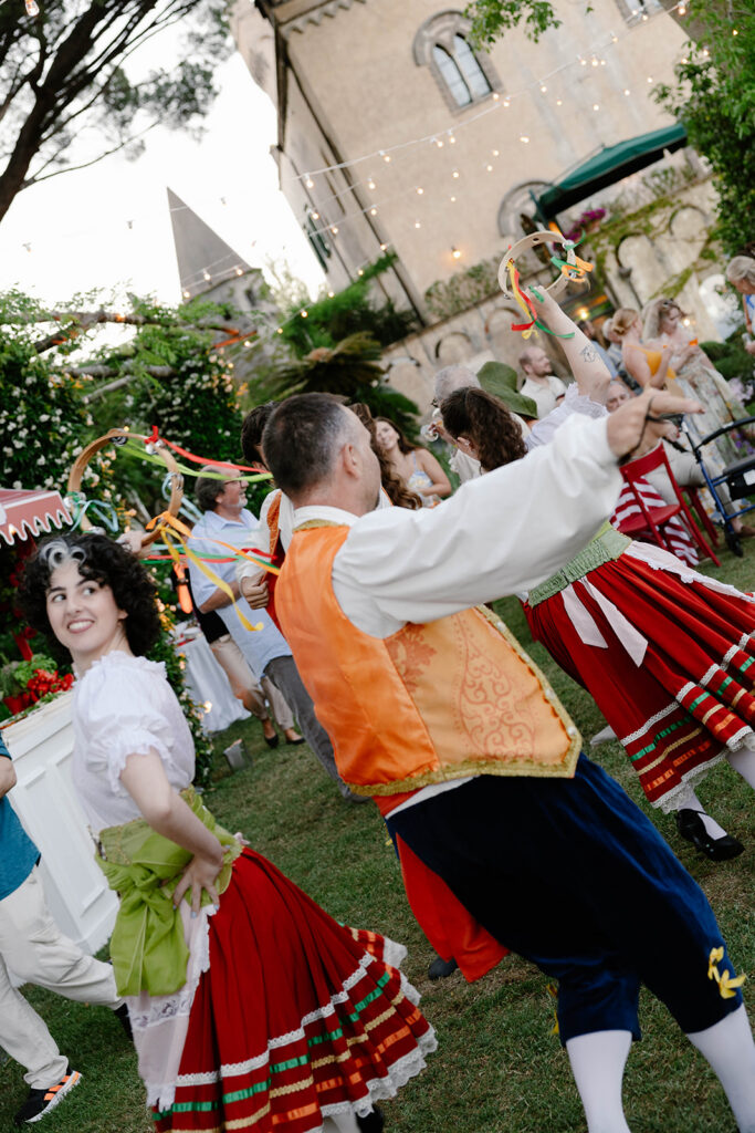 Performers in traditional Italian folk costume at a Villa Cimbrone wedding celebration