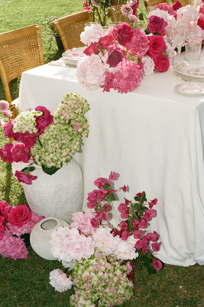 Pink and green floral arrangement in a white urn, Villa Cimbrone wedding reception
