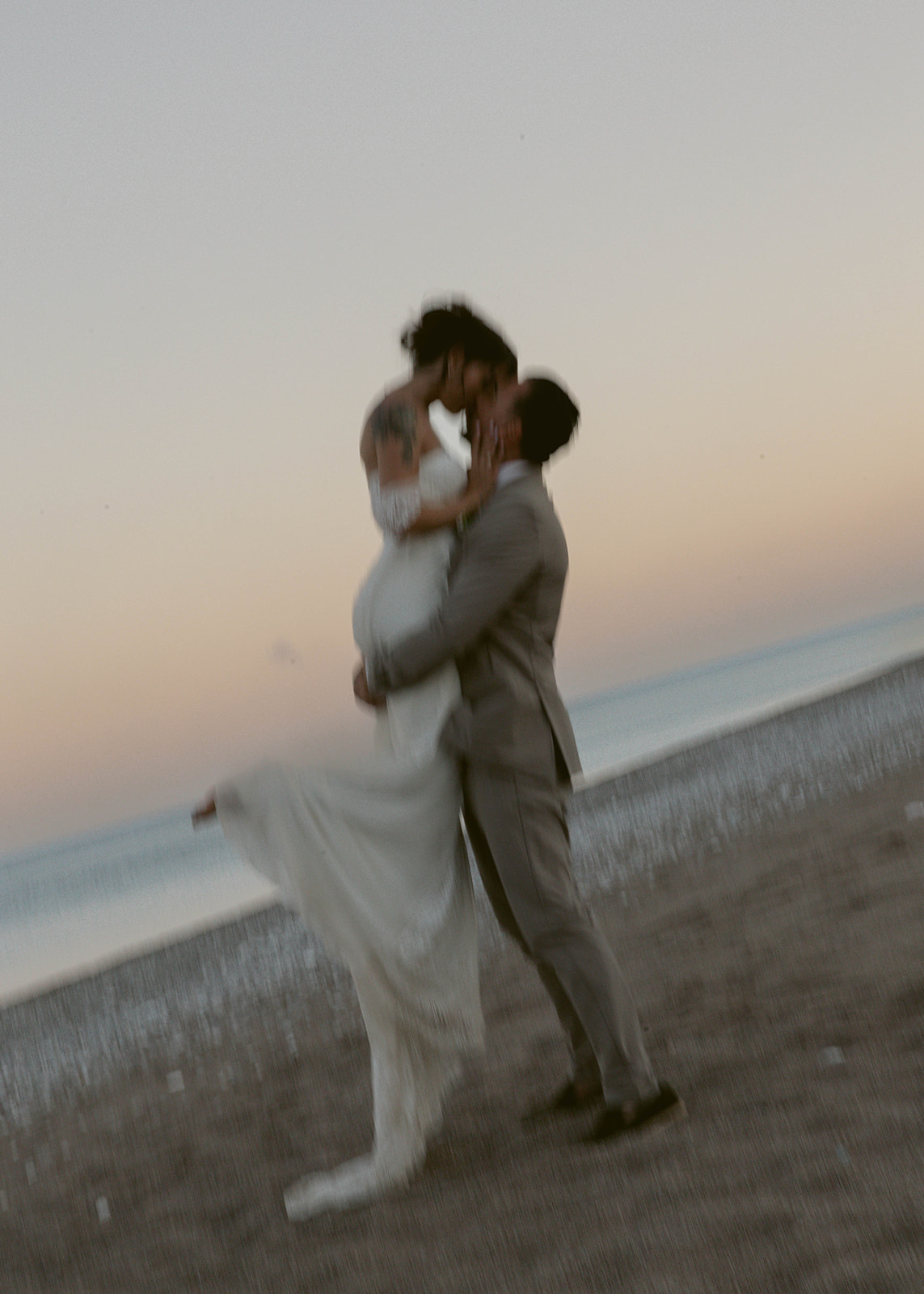 Bride and groom embracing at sunset on the beach, Rhodes, Greece wedding